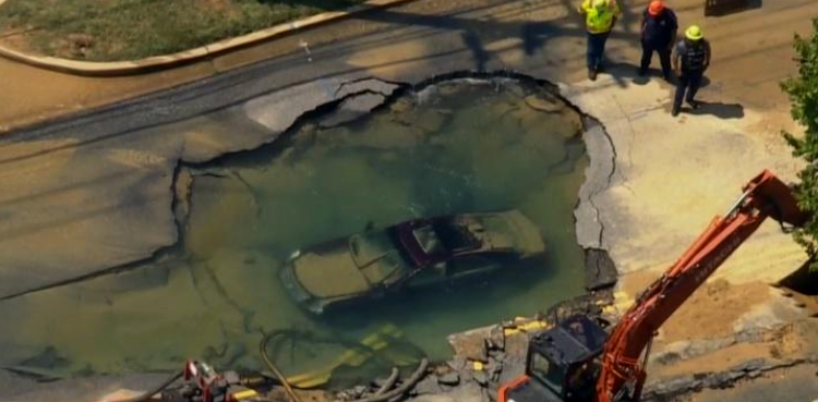 Cadillac driver sinkhole signs